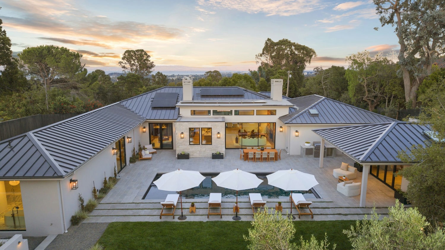 Aerial view at dusk of a custom home built by Nejasmich Developments on the San Francisco Peninsula
