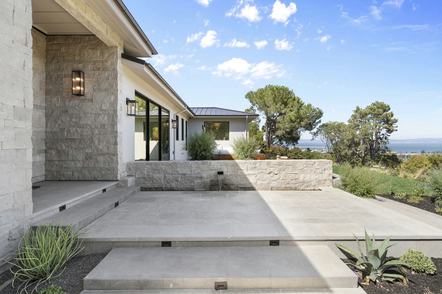 Front porch and fountain courtyard of a custom home by Nejasmich Developments