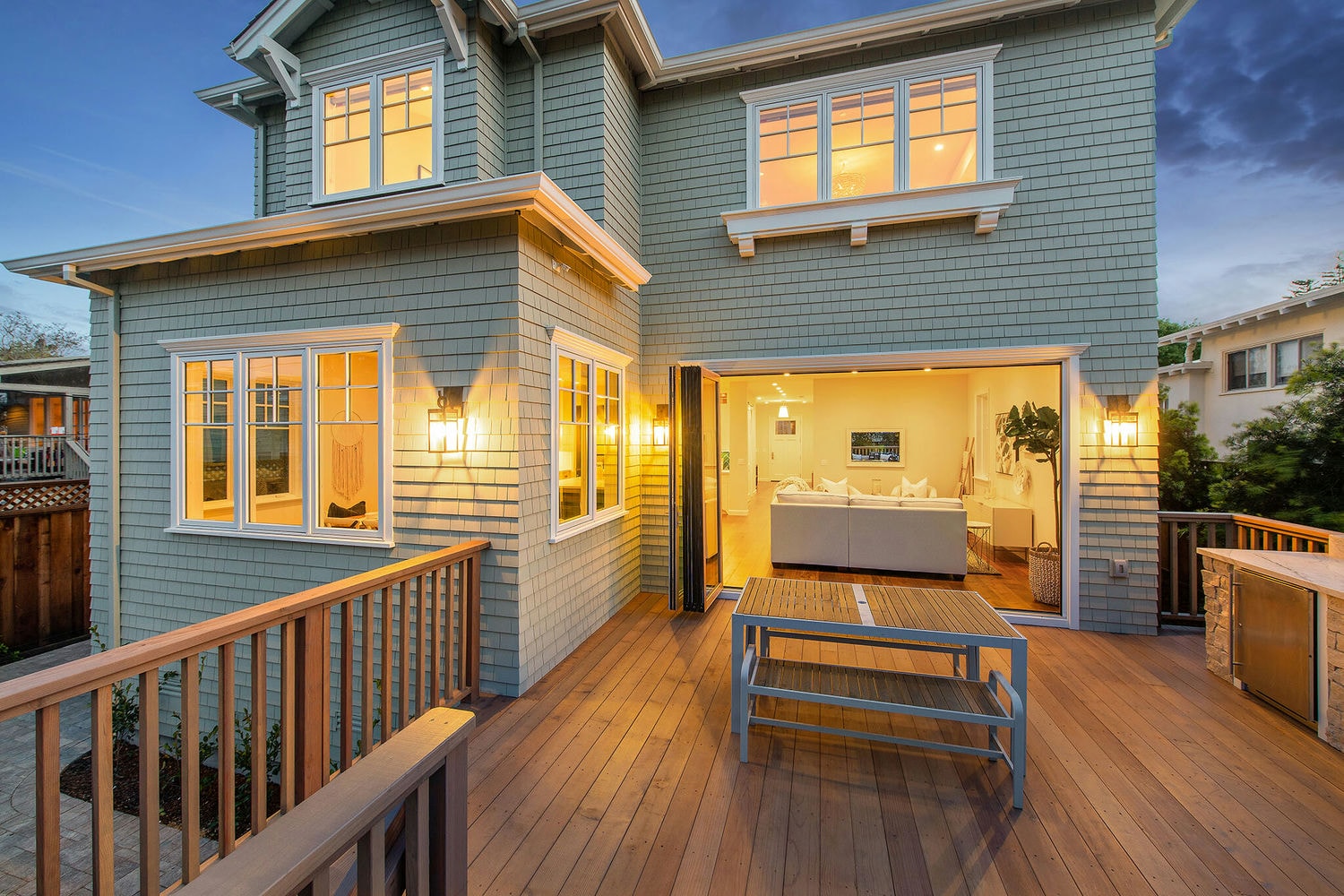Rear deck of a custom home at twilight, built by Nejasmich Developments
